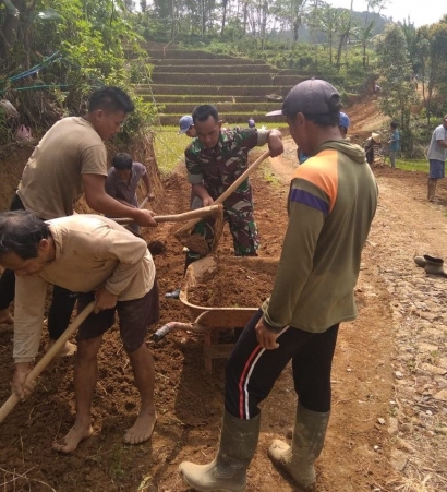 Babinsa Desa Salamwates Serda Harianto Bantu Warga Karya Bakti Pelebaran Jalan